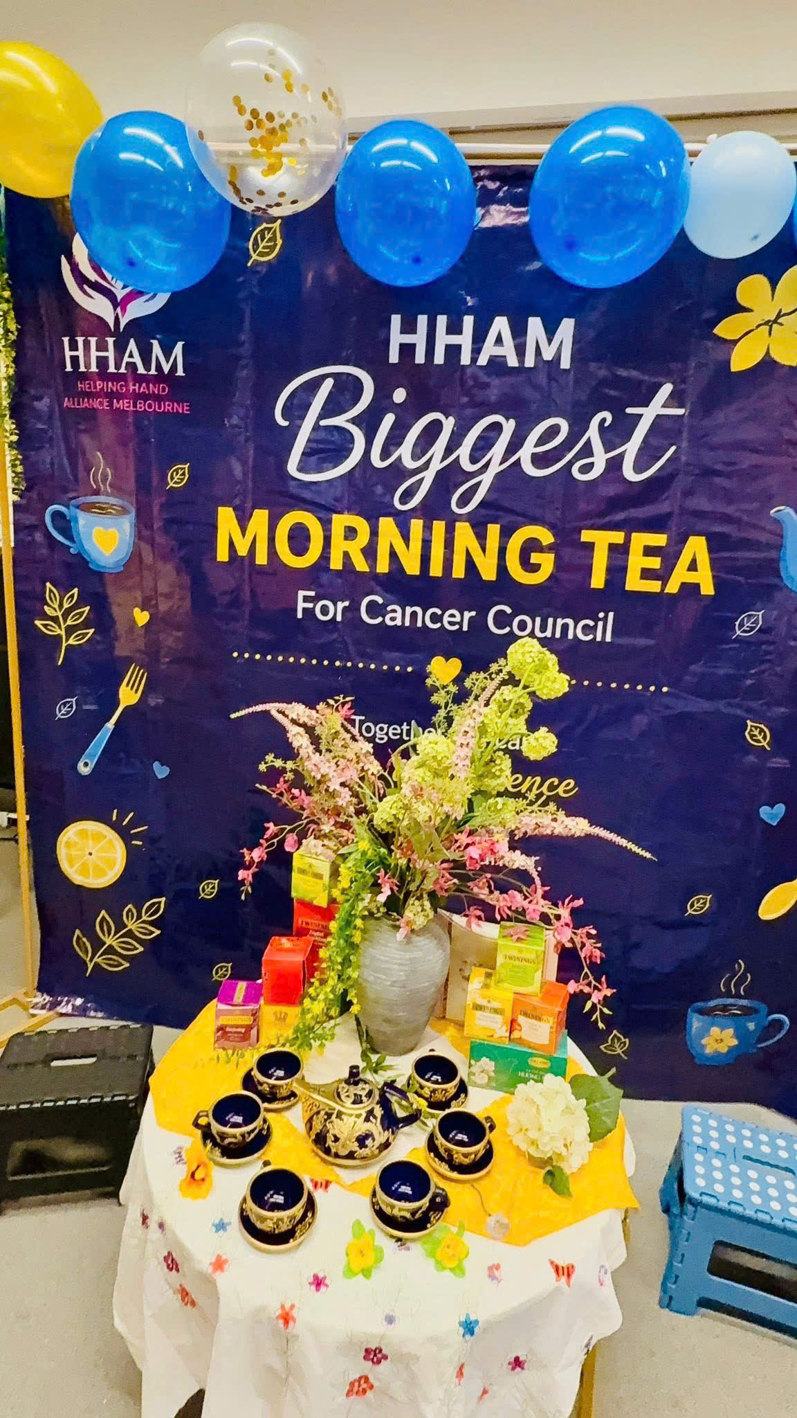 HHAM's Biggest Morning Tea 2026 — decorated tea table with Cancer Council banner